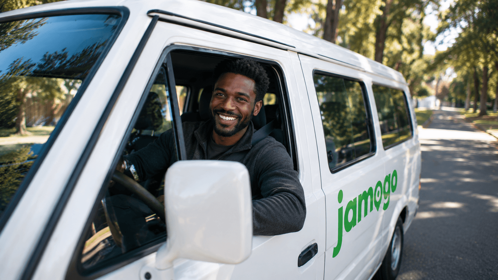 Photo - smiling Jamogo driver leaning out of their van